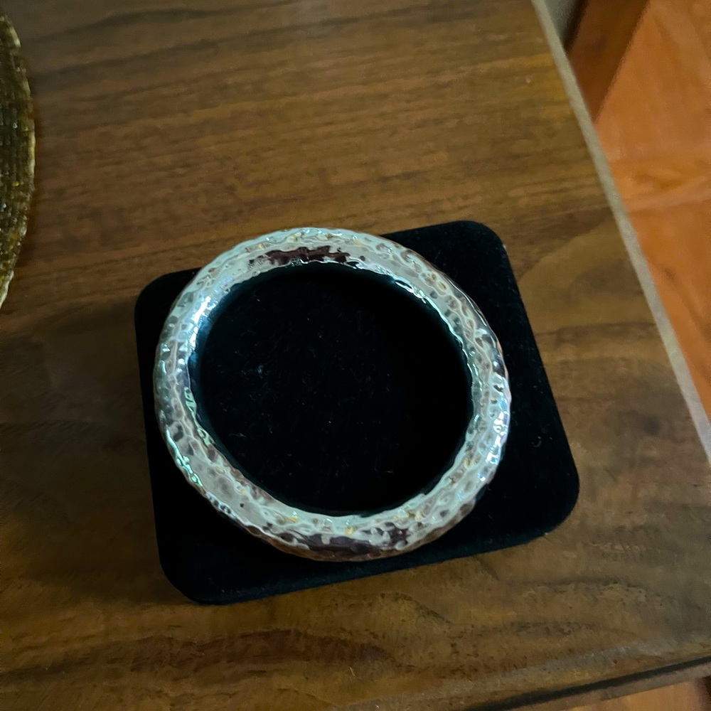 Thick chunky silver bangle bracelet is solid silver with 925 engraved in metal.